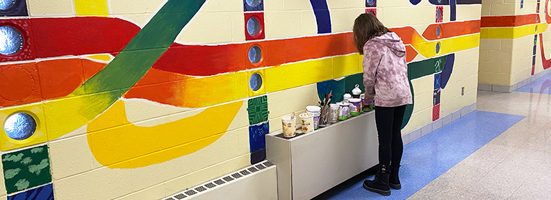 Student painting hallway