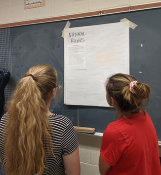 Students reading board